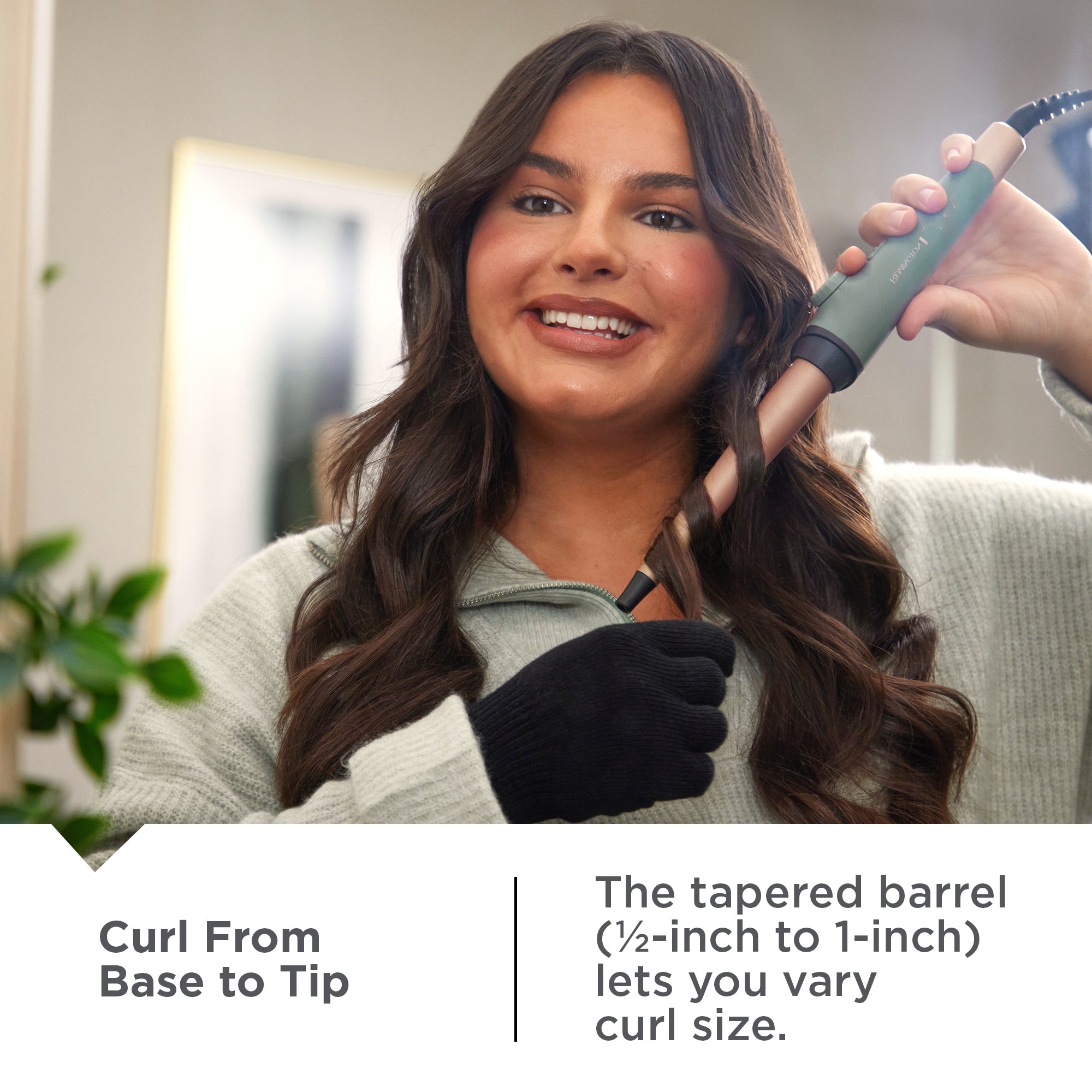 Woman using a Botanicals™ Tapered Curling Wand hair styling tool