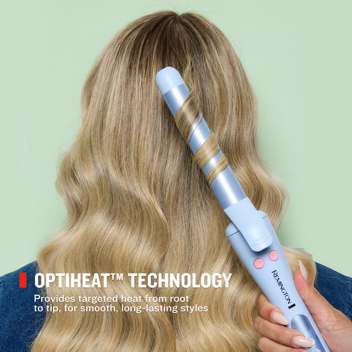 A close-up of a person using Trendology 1" Rotating Curling Iron on long blonde hair.