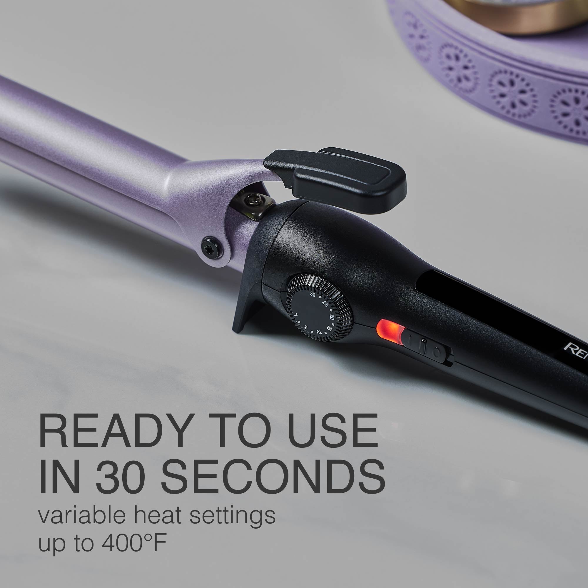 Purple curling wand with black control panel on a gray background