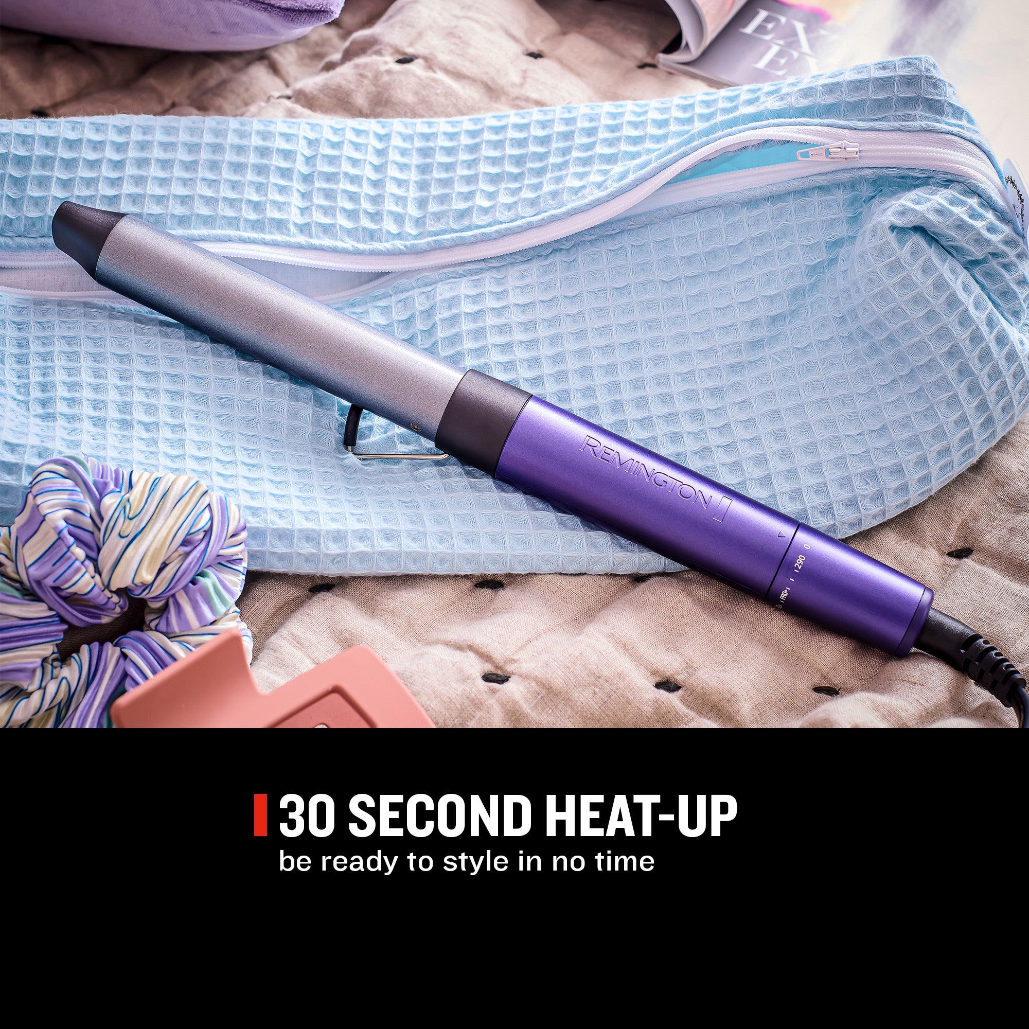 A Remington hair straightener iron in metallic silver and purple, resting on a light blue waffle-textured pouch over a beige quilted blanket. A black banner at the bottom reads '30 SECOND HEAT-UP be ready to style in no time'.