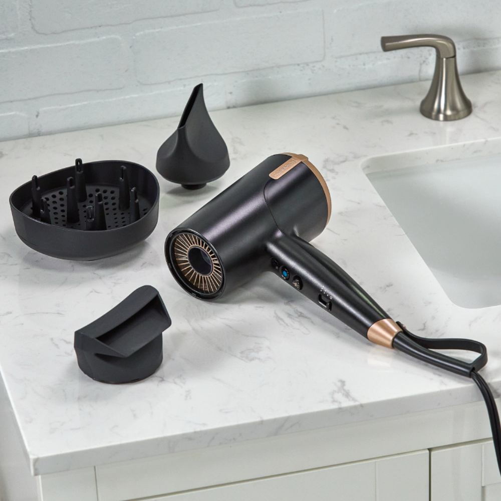 D31A10 Black hair dryer with attachments on a bathroom counter