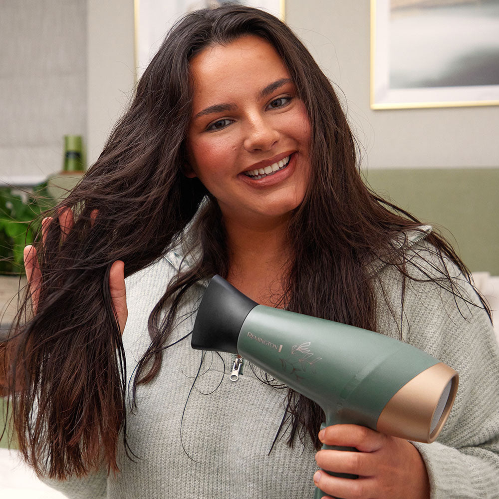 Woman using Botanicals™ Hair Dryer drying her hair