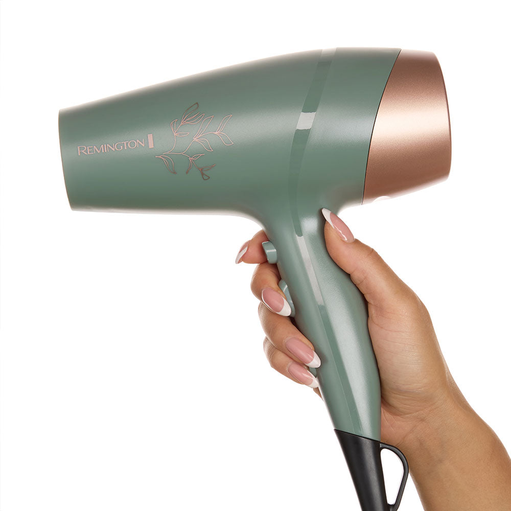 Botanicals™ Hair Dryer held by a hand on a white background