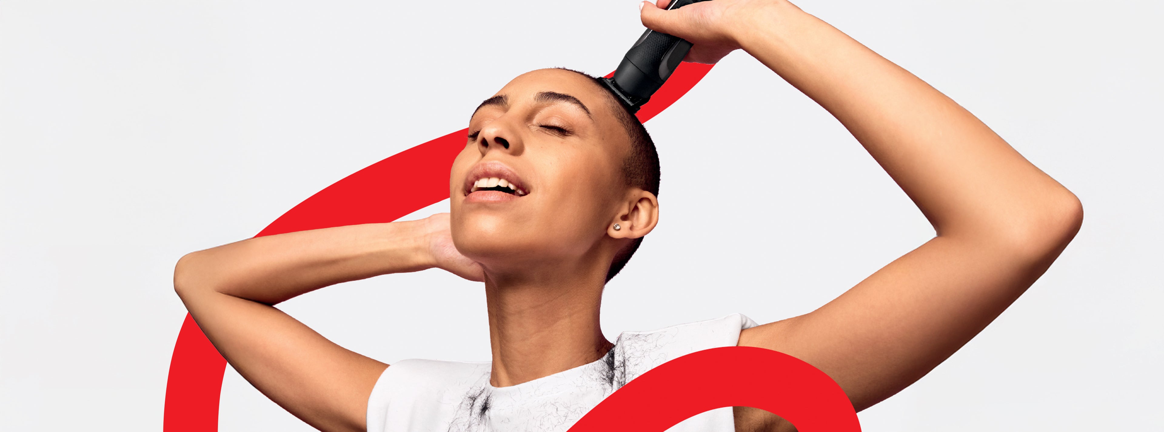 Woman with shaved head shaving hair with red line in the background