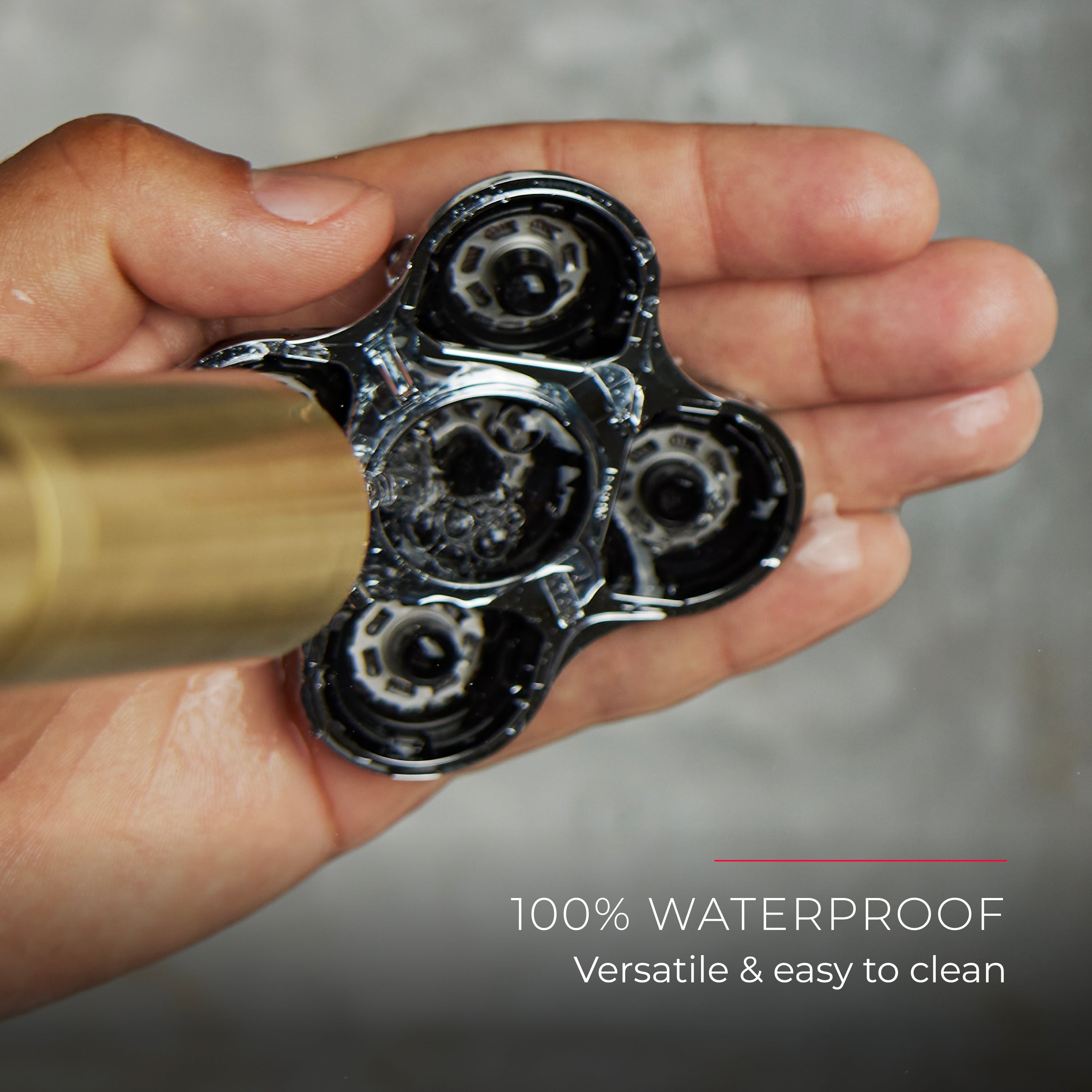 A close-up of a hand cleaning shaver head part