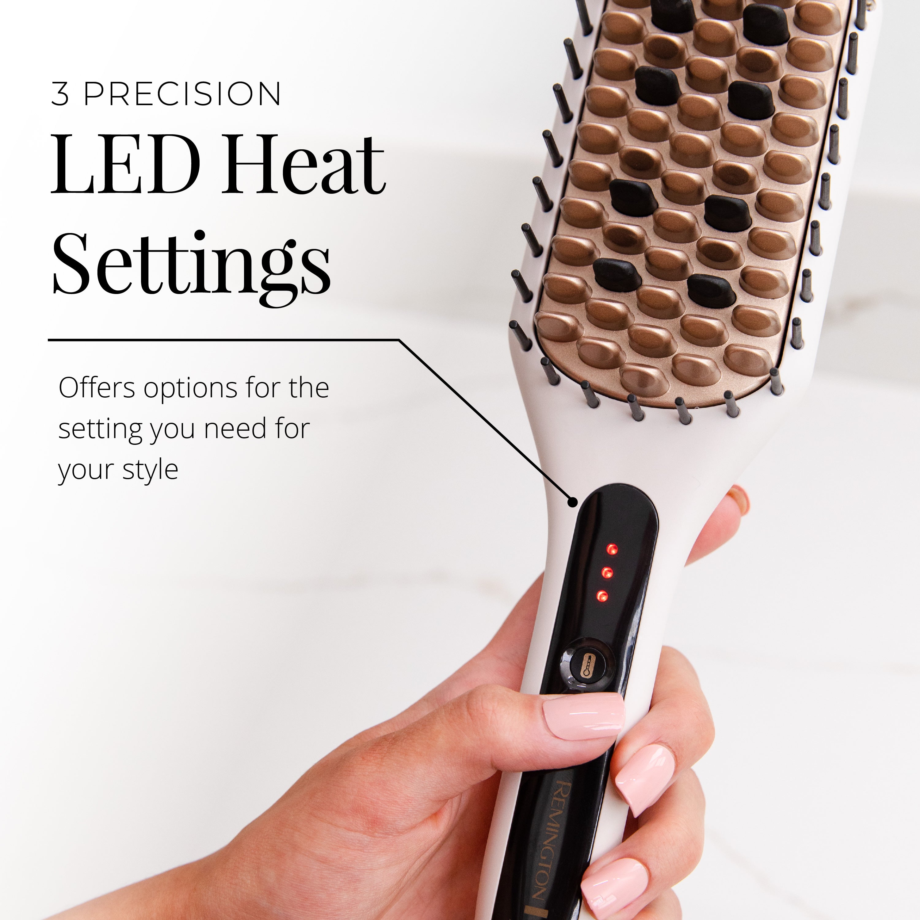 Hair straightener with LED heat settings held by a hand on a white background