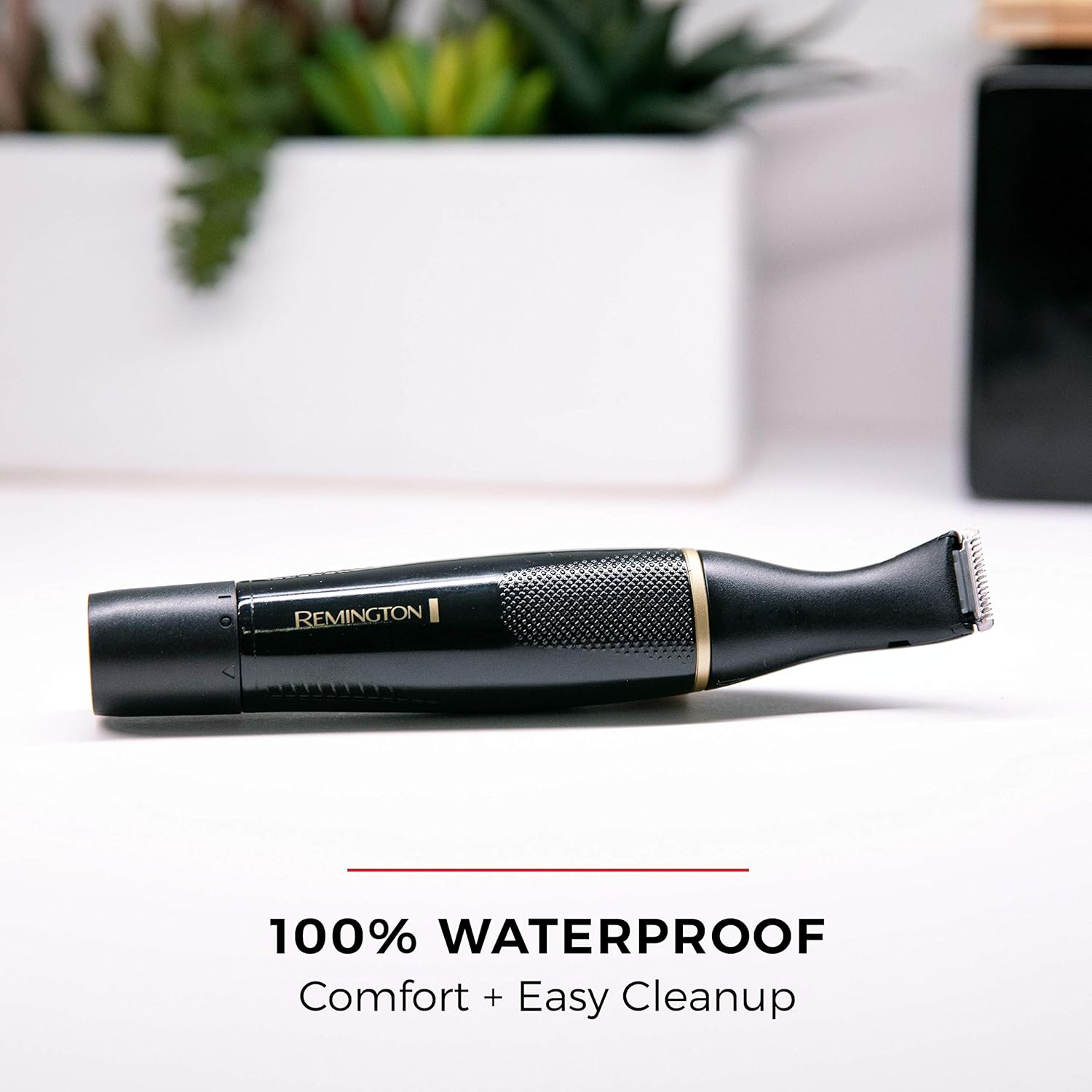 Remington grooming tool on a white surface with text highlighting waterproof feature