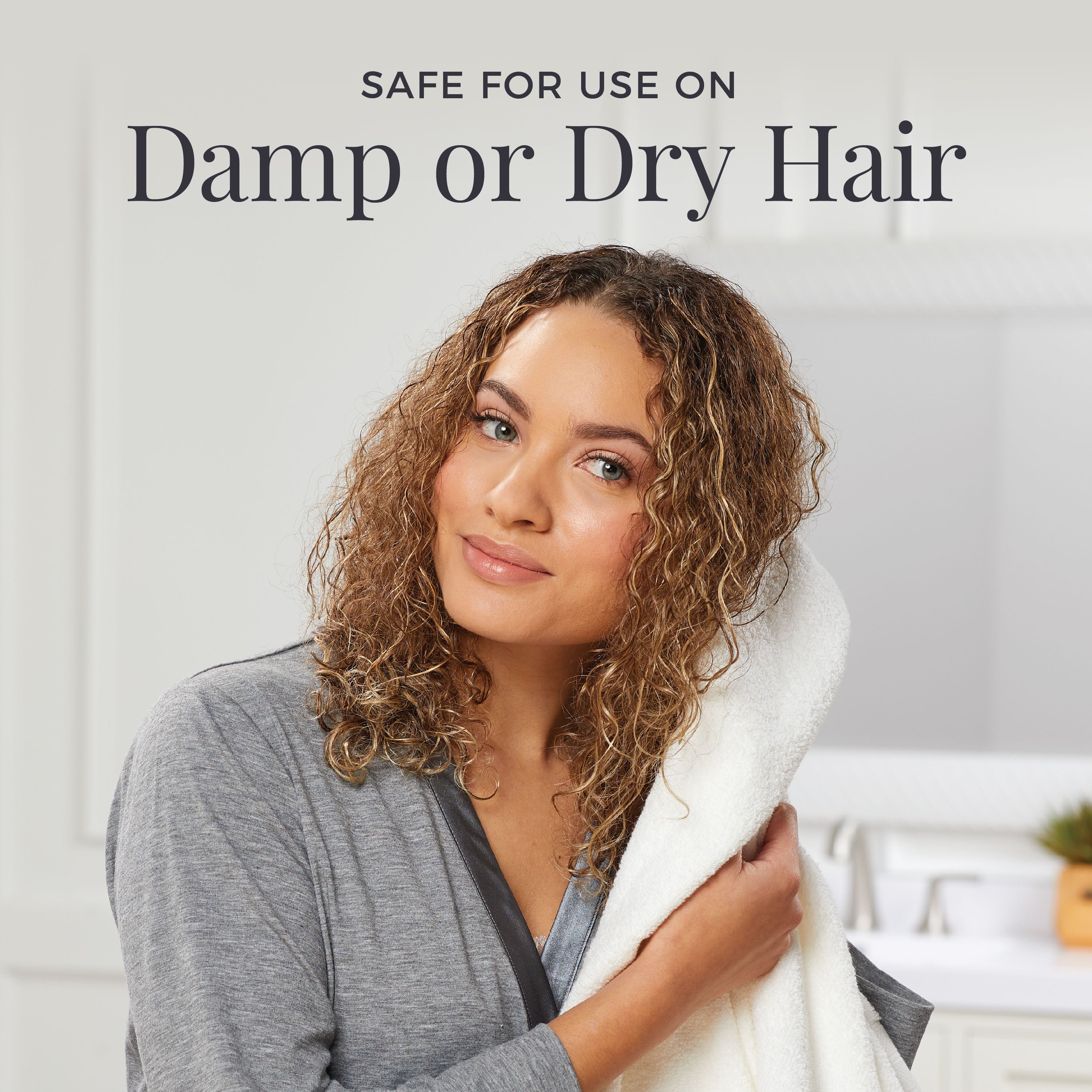 Woman with curly hair holding a towel, with text indicating product safety for damp or dry hair.