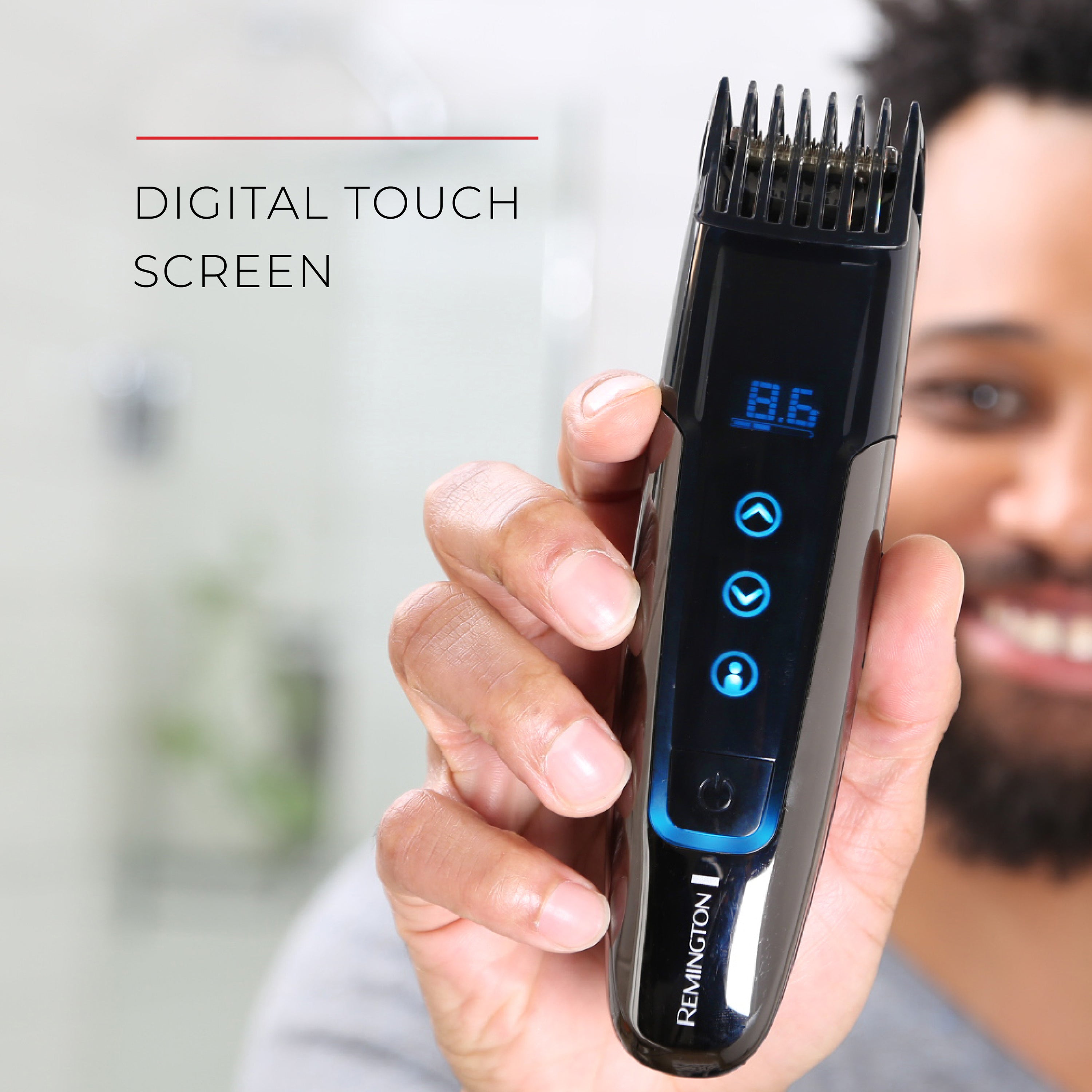 Hair trimmer with digital touch screen held by a person, brand 'Remington' visible