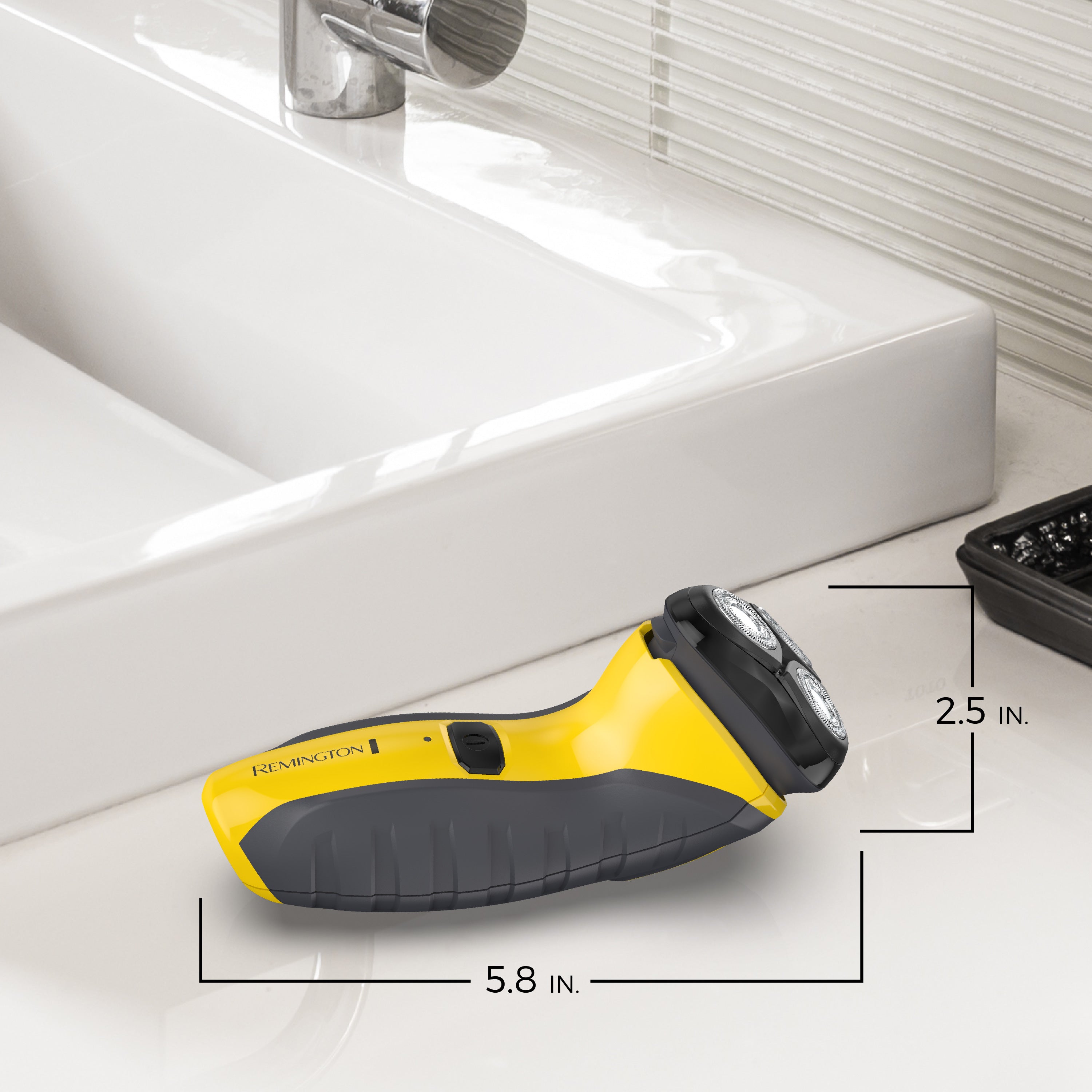 Yellow and black electric razor on a bathroom counter with measurements indicated