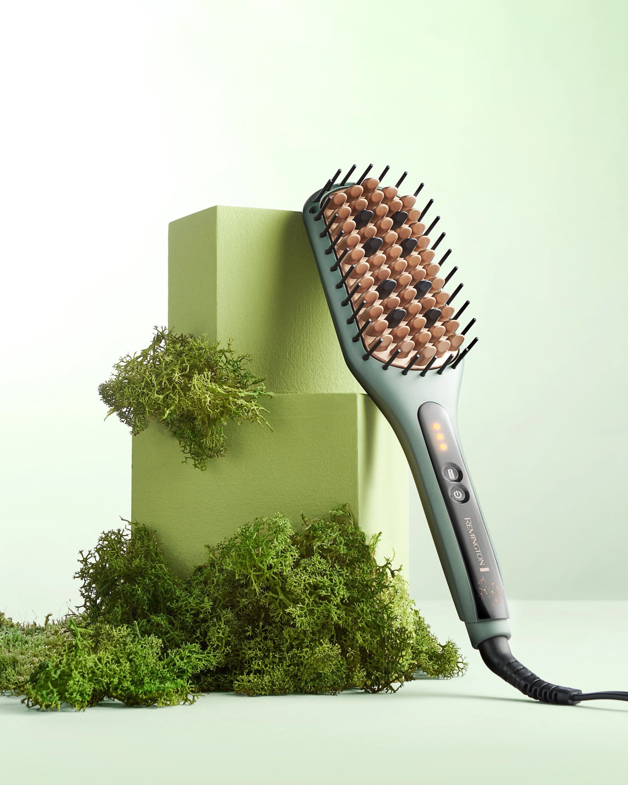 Botanical- Hair straightening brush with brown bristle head on a light green background