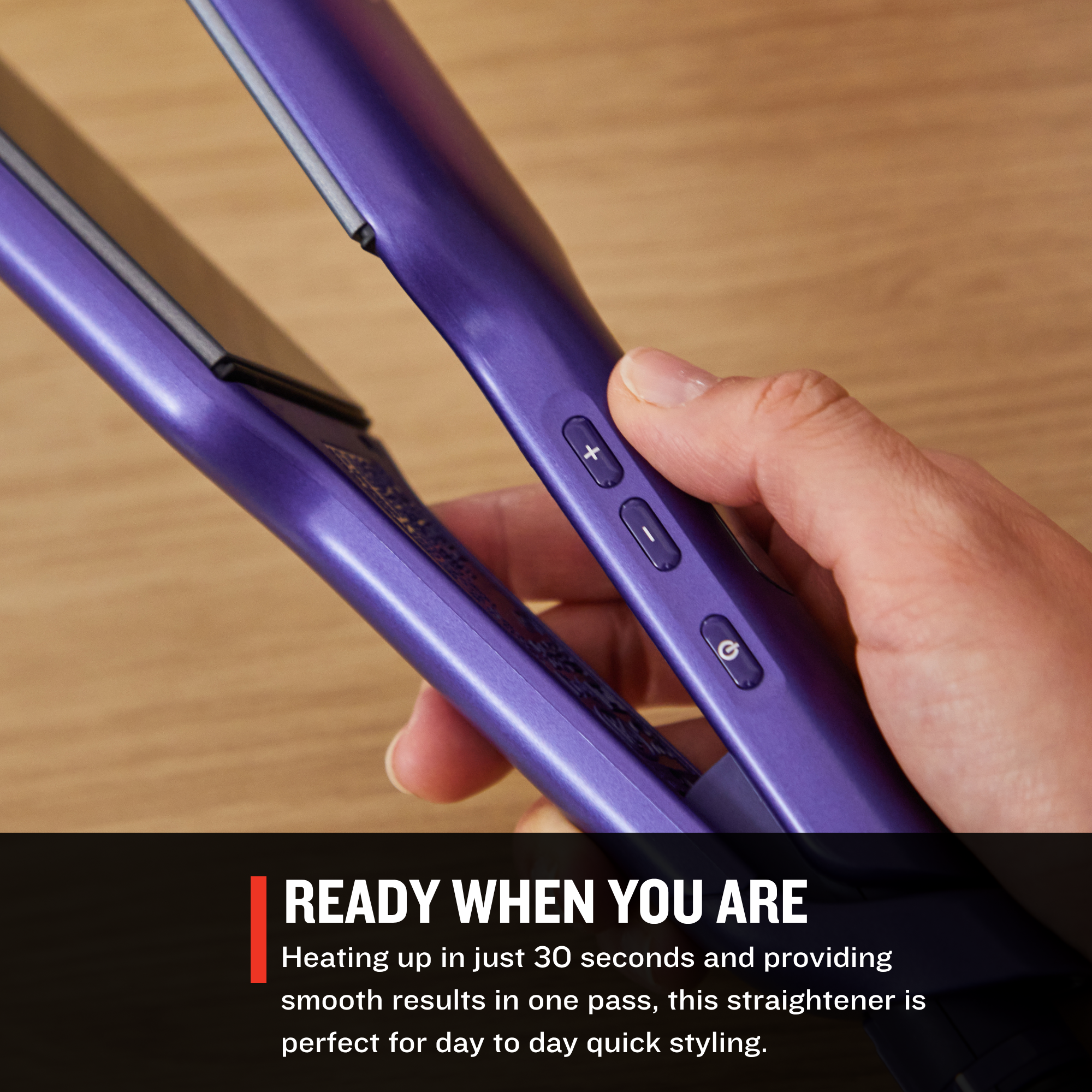 S9355US Gloss™ 2 in Flat Iron held by a hand on a wooden surface with text about its quick heating time and ease of use.