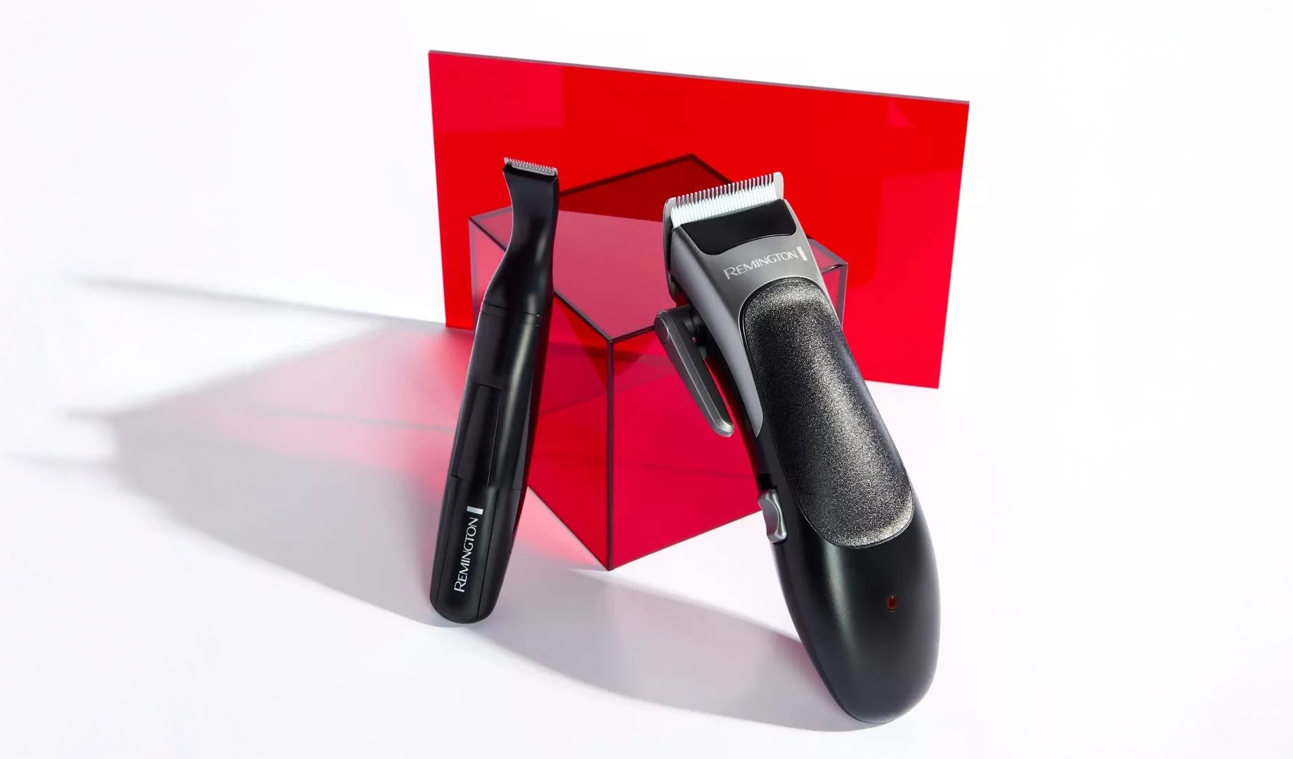 Two trimmers leaning against a plastic cube