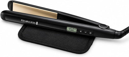 A black Remington hair straightener with a digital temperature display, resting on a black fabric pouch against a white background.