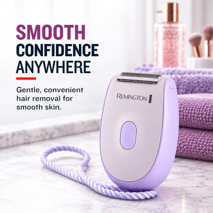 A Remington electric hair remover in light purple and white, shown on a marble countertop with a matching purple cord. In the background, purple towels and a pink cosmetic bottle are visible, with promotional text on the left reading 'SMOOTH CONFIDENCE ANYWHERE'.