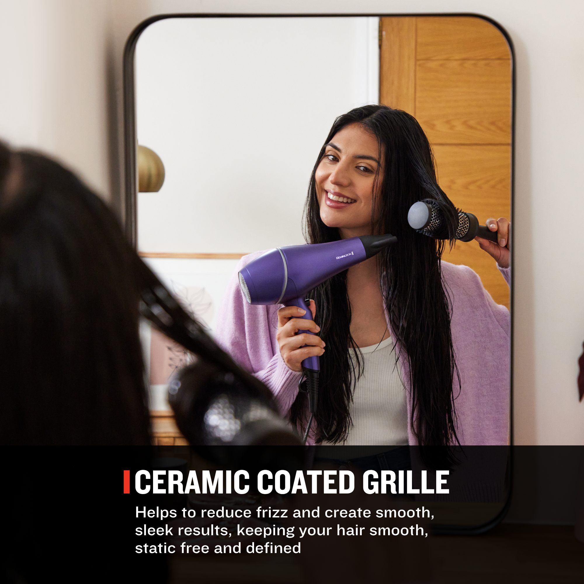 A woman uses a purple hair dryer on her hair, seen in a mirror. Text at the bottom reads 'ICERAMIC COATED GRILLE' with descriptive copy about reducing frizz and creating smooth, sleek results.