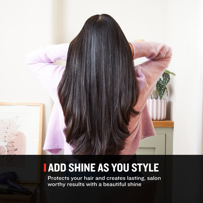 A woman viewed from behind with long, straight, glossy dark brown hair, wearing a light pink ribbed sweater in a bright indoor setting. A text banner at the bottom reads 'ADD SHINE AS YOU STYLE' with supporting hair-care copy.