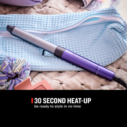 A Remington hair straightener iron in metallic silver and purple, resting on a light blue waffle-textured pouch over a beige quilted blanket. A black banner at the bottom reads '30 SECOND HEAT-UP be ready to style in no time'.