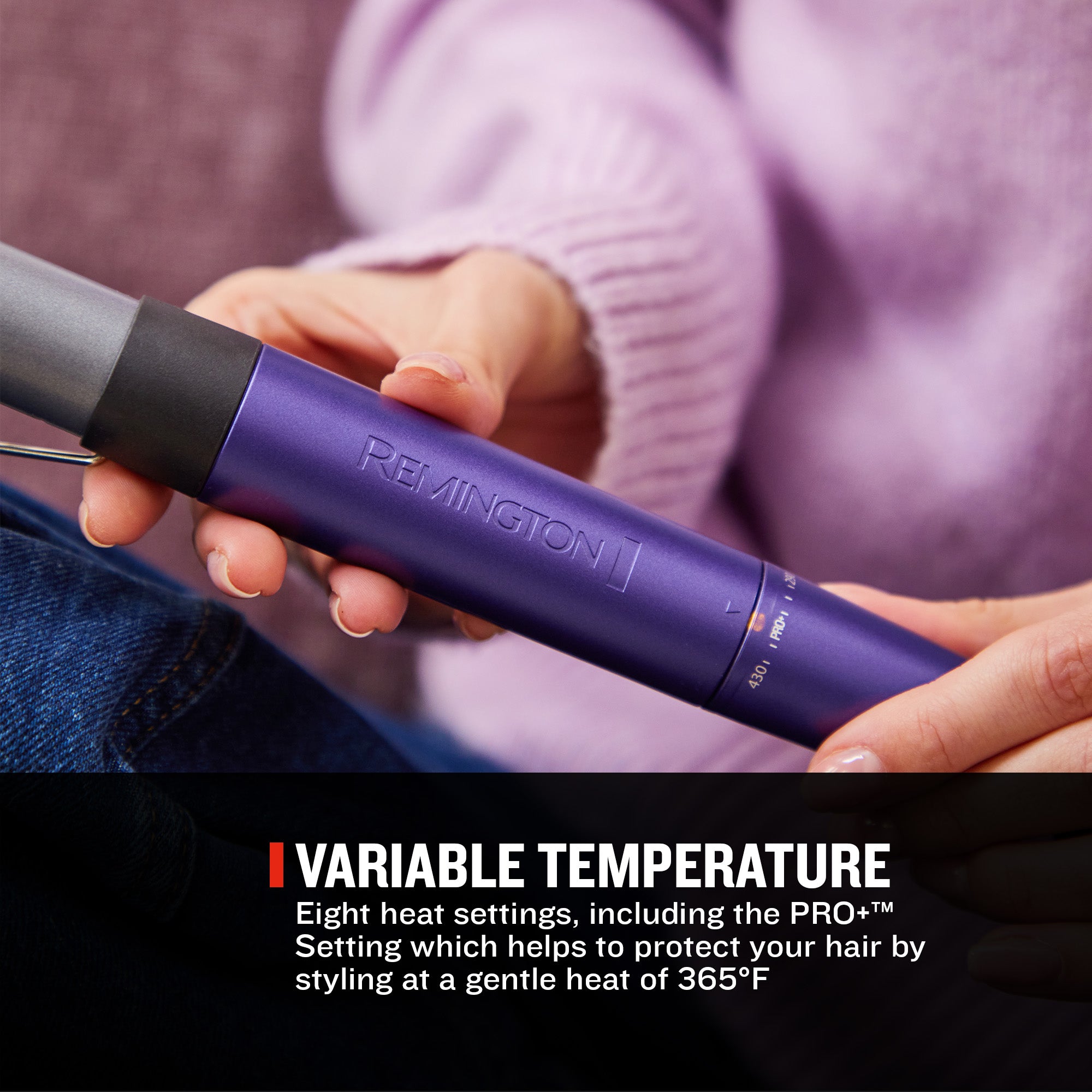 A person holding a purple Remington hair straightener in their hands, with a black barrel and a black text banner at the bottom that reads 'VARIABLE TEMPERATURE'.