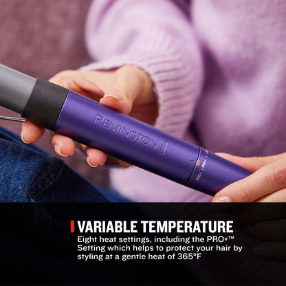 A person holding a purple Remington hair straightener in their hands, with a black barrel and a black text banner at the bottom that reads 'VARIABLE TEMPERATURE'.