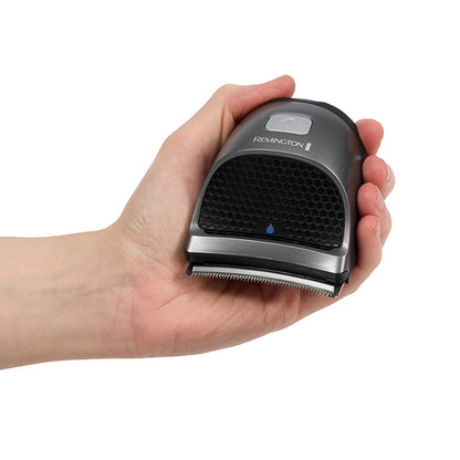 Hand holding a Remington grooming tool on a white background