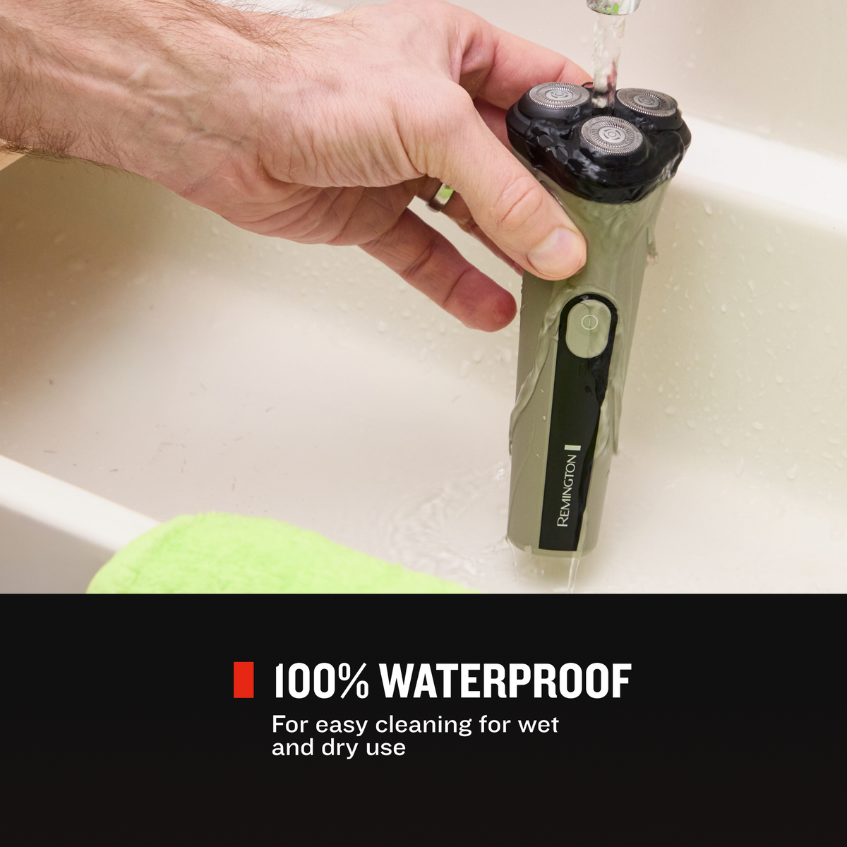 Person cleaning RC3370 shaver under running water in a white sink.