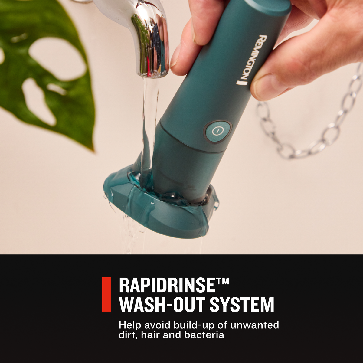 A hand holds RC4380 Rotary Shaver under running water rinsing shaver head.