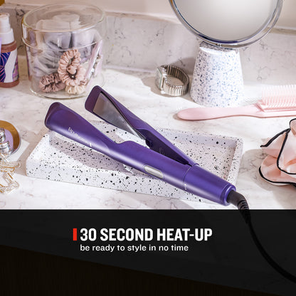 A purple flat iron hair straightener resting on a white speckled tray on a marble countertop, surrounded by beauty accessories like a mirror, comb, and jar. A black banner at the bottom reads '30 SECOND HEAT-UP be ready to style in no time'.