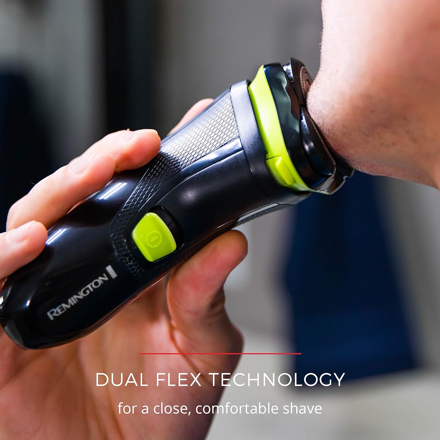 Person using a Remington electric shaver with dual flex technology on a blurred background