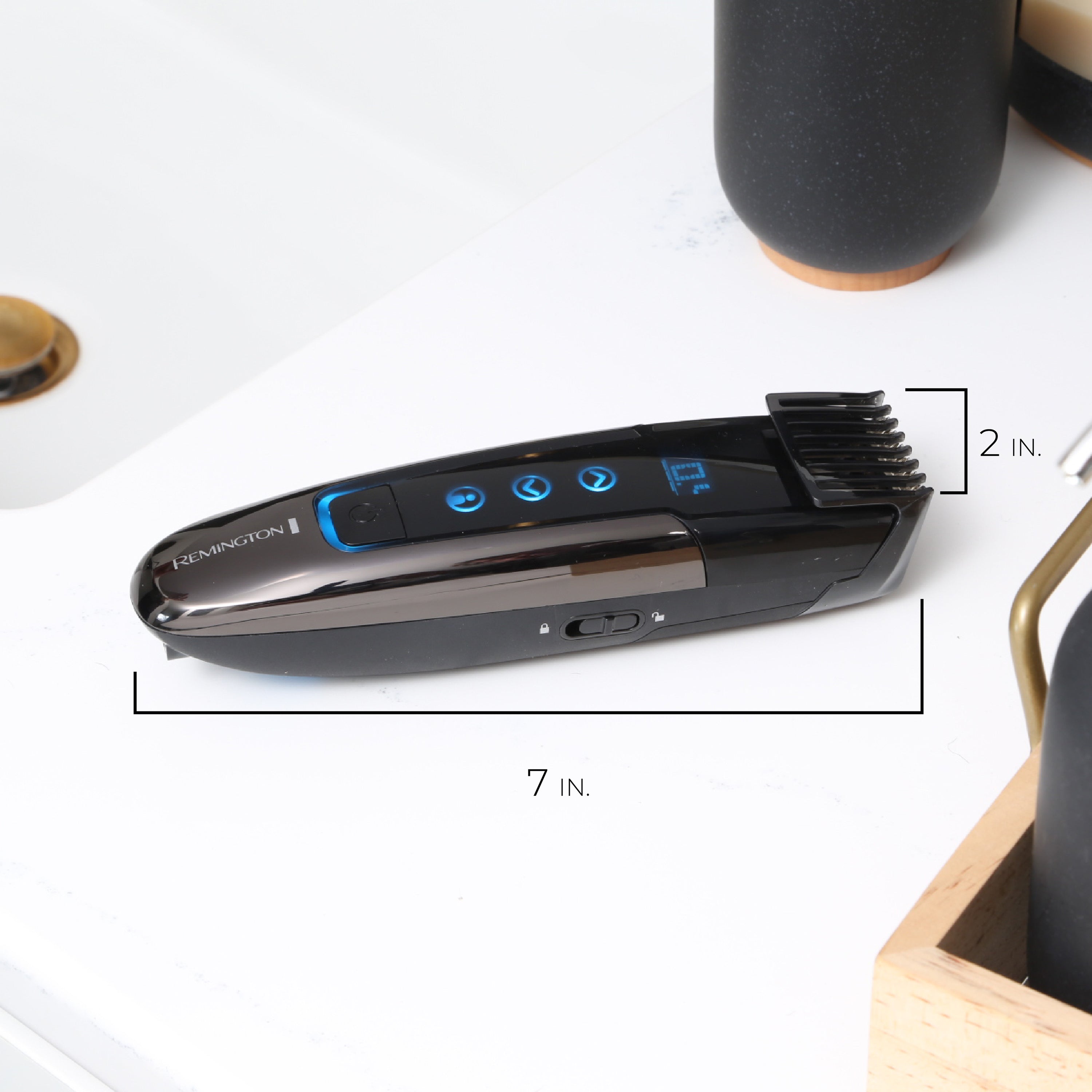 Hair trimmer on a white surface with measurements indicated