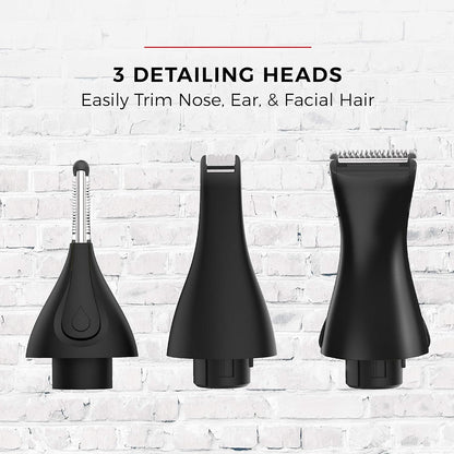 Three black detailing heads for grooming on a white brick wall background.