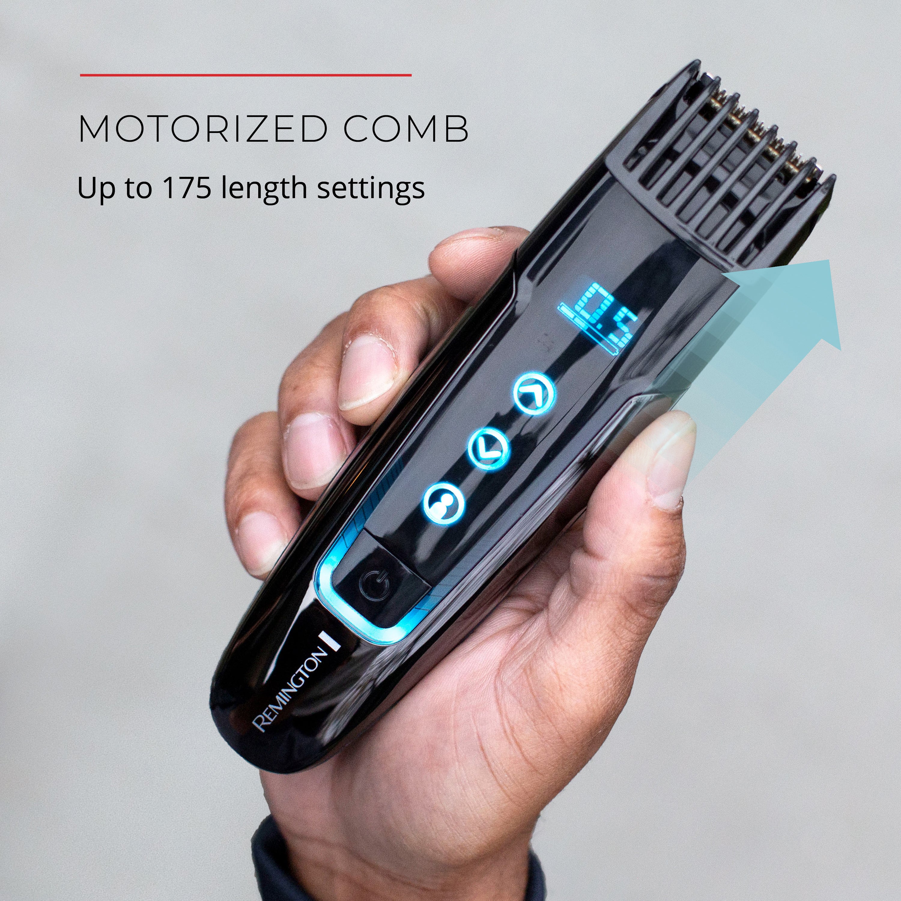 Motorized comb held in a hand with Remington branding on a gray background