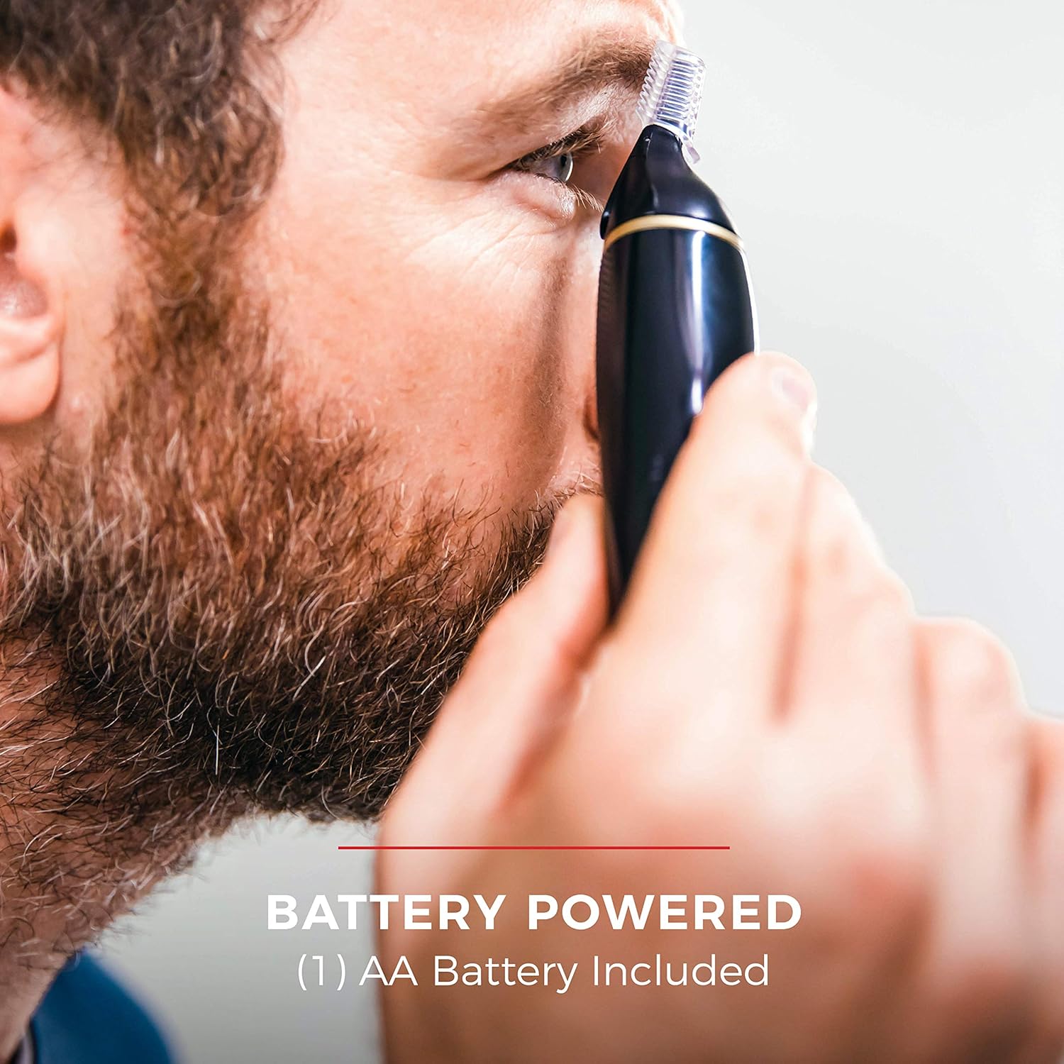 Man using a battery-powered ear cleaning tool with text indicating battery power and included AA battery.