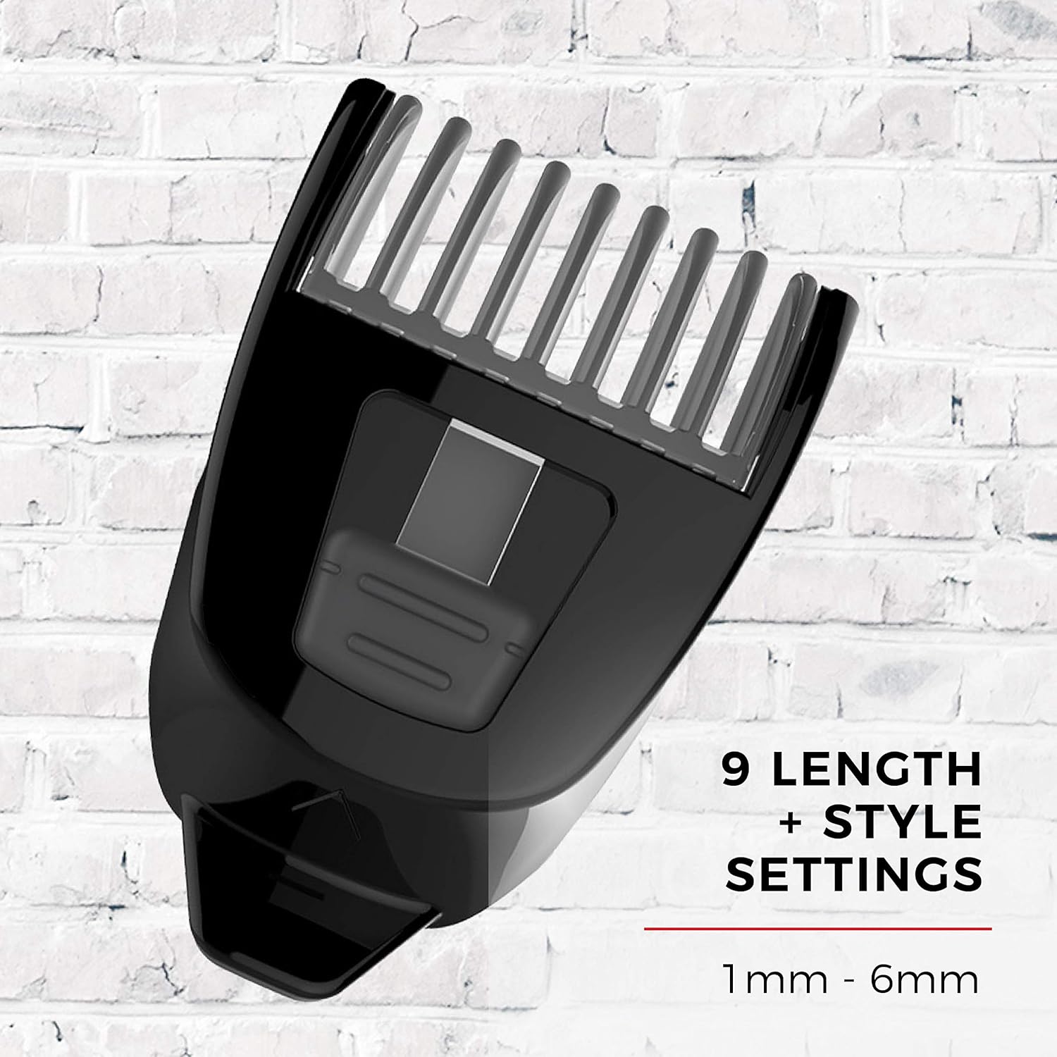 Black hair clipper comb attachment on a white brick wall background
