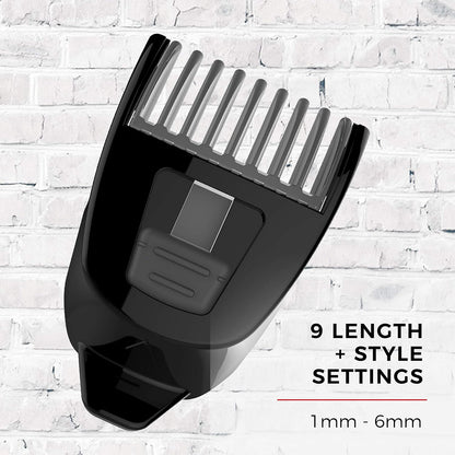 Black hair clipper comb attachment on a white brick wall background