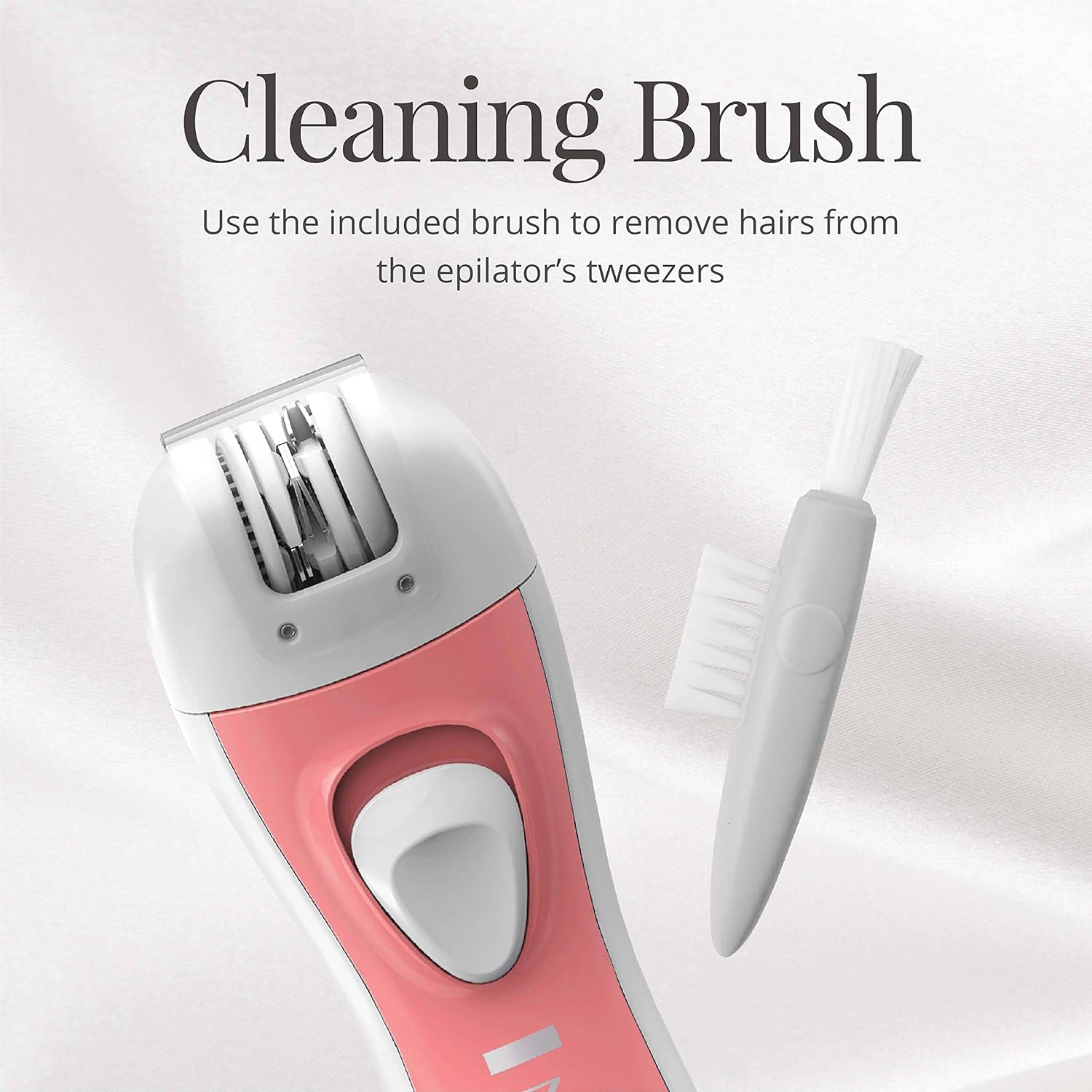 Pink epilator with cleaning brush on a light gray background