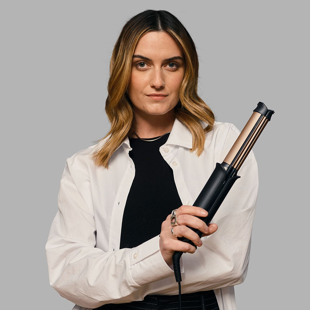 woman holding a 2 in one styler- Remington One Styler