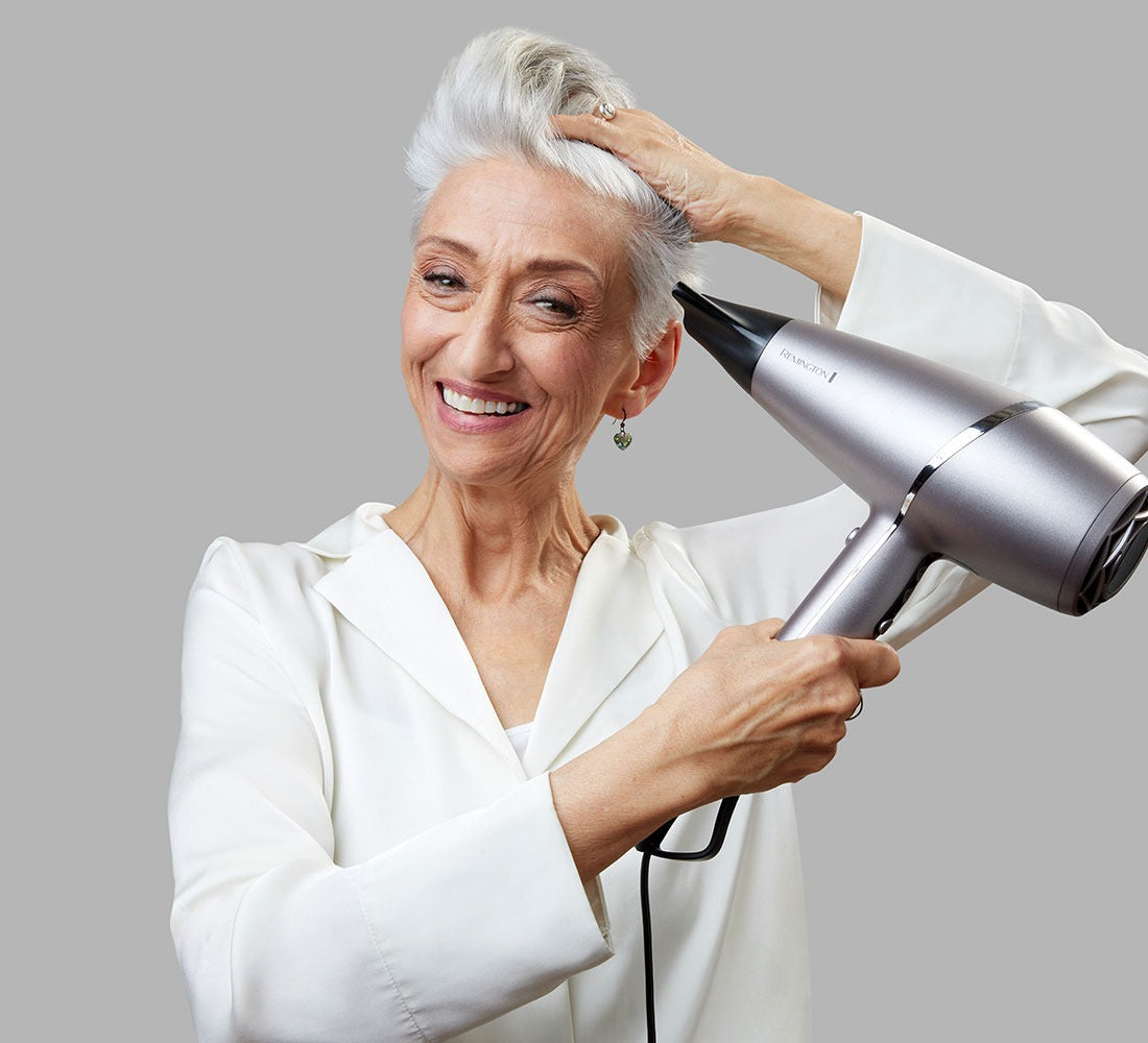 women with short silver hair drying hair