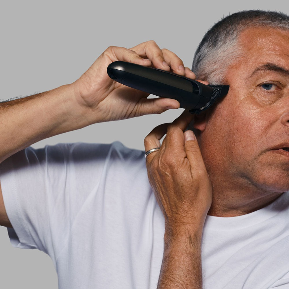 man trimming side burns