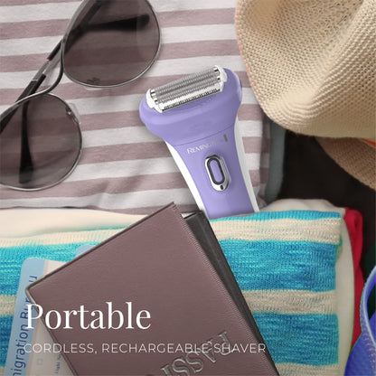 Purple rechargeable shaver on a striped fabric background with sunglasses and a hat.