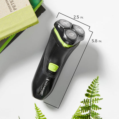 Black and green electric shaver with measurements on a light background