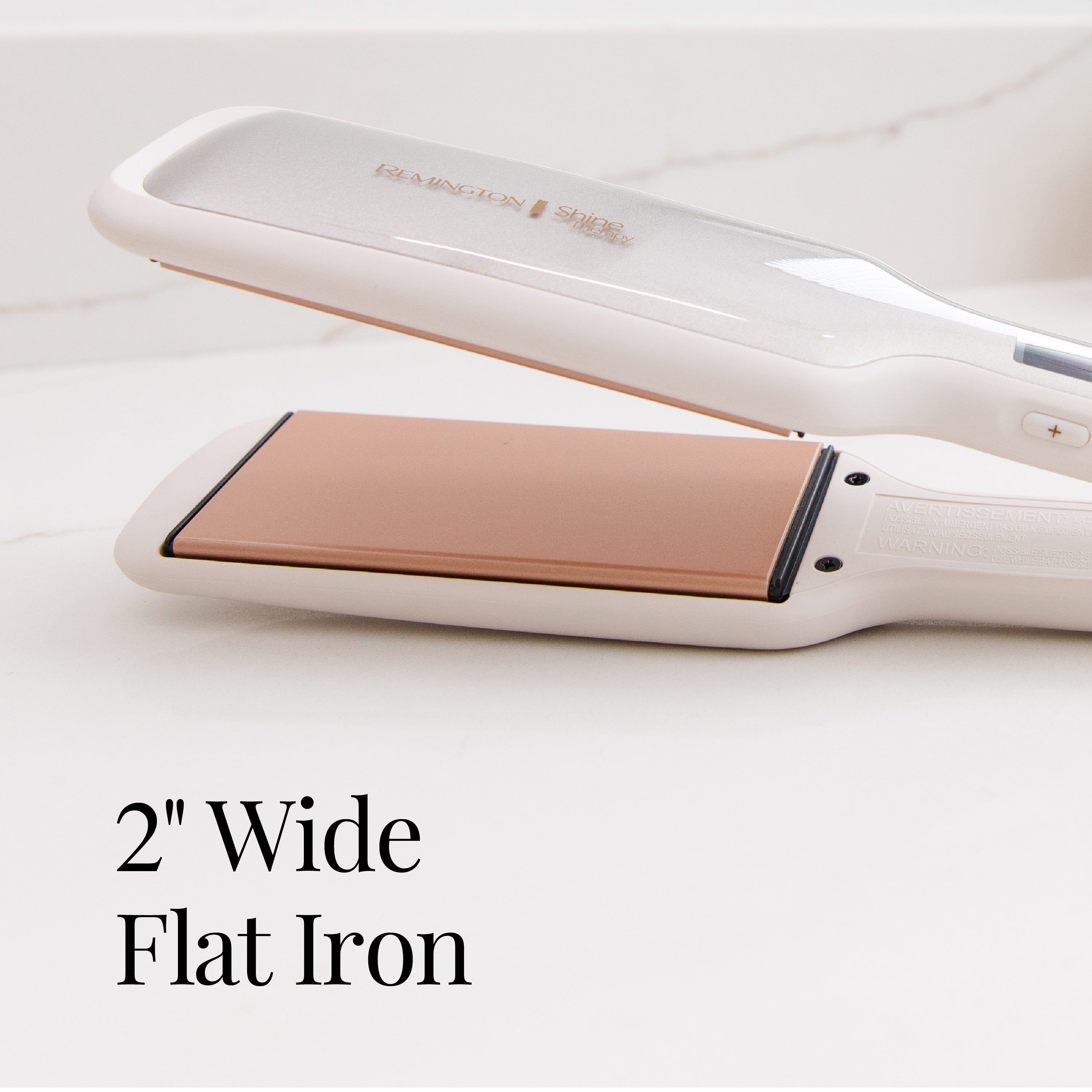 White and rose gold flat iron on a light background with text '2" Wide Flat Iron'.