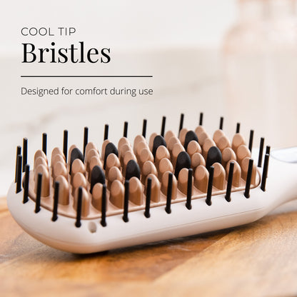Hairbrush with cool tip bristles on a wooden surface