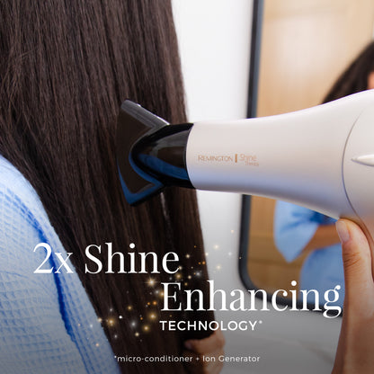 Hair dryer with '2x Shine Enhancing Technology' feature being used on hair.