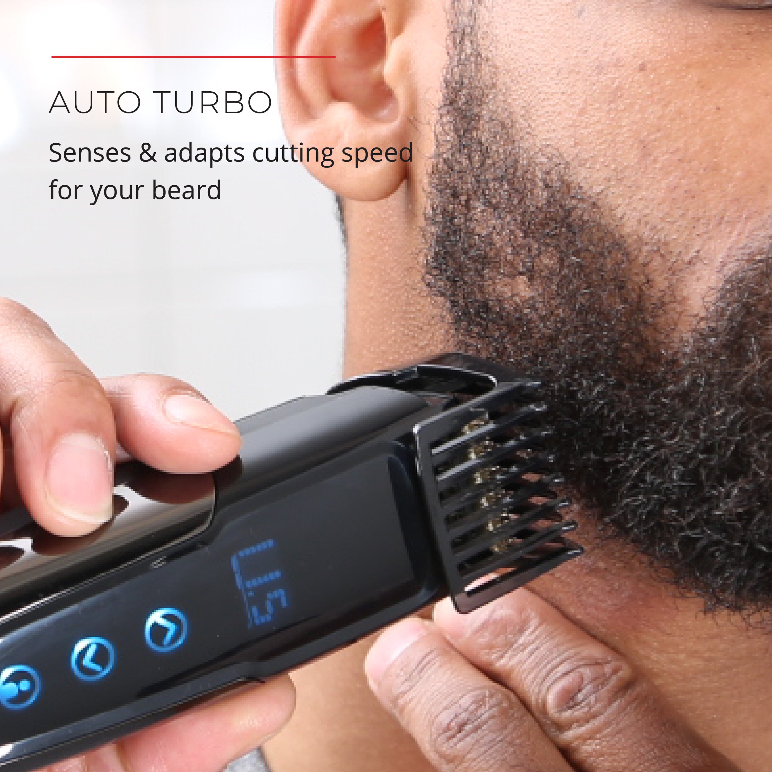 Person using a beard trimmer with auto-turbo feature on a blurred background