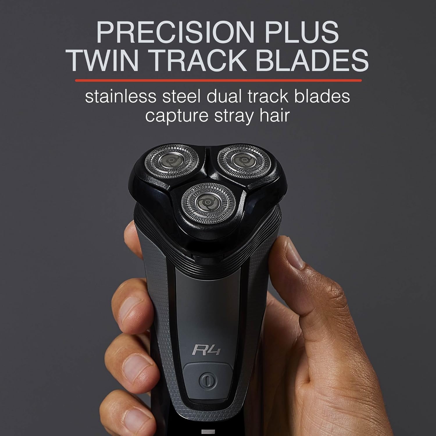 Black electric shaver with 'PRECISION PLUS TWIN TRACK BLADES' text on a dark background